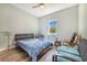 This cozy bedroom features natural light and hardwood floors at 6344 Old Lake Wilson Rd, Davenport, FL 33896