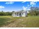 Exterior view of home with covered porch and an open yard at 6344 Old Lake Wilson Rd, Davenport, FL 33896