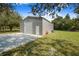Exterior shot of a large metal building with a garage door and separate entry door at 6344 Old Lake Wilson Rd, Davenport, FL 33896