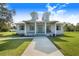 Charming home featuring a welcoming covered porch with a swing, perfect for relaxation at 6344 Old Lake Wilson Rd, Davenport, FL 33896