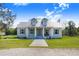 Charming single story home showcasing a welcoming front porch with columns and a manicured lawn at 6344 Old Lake Wilson Rd, Davenport, FL 33896