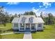 Inviting home with a metal roof, dormers, and a covered porch at 6344 Old Lake Wilson Rd, Davenport, FL 33896