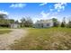 Charming country home with a metal roof and a spacious, well-maintained front yard at 6344 Old Lake Wilson Rd, Davenport, FL 33896