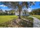 Charming front yard with mature trees and a walkway leading to the front porch at 6344 Old Lake Wilson Rd, Davenport, FL 33896