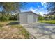 New metal garage on expansive lot features concrete driveway and convenient roll-up door at 6344 Old Lake Wilson Rd, Davenport, FL 33896