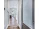 Hallway with wood floors leading to various rooms; a laundry room is on the right at 6344 Old Lake Wilson Rd, Davenport, FL 33896