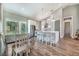 Modern kitchen with island seating, stainless steel appliances, and a dining area at 6344 Old Lake Wilson Rd, Davenport, FL 33896