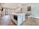 Kitchen island with seating, modern appliances, and hardwood floors in an open layout at 6344 Old Lake Wilson Rd, Davenport, FL 33896
