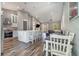 Open kitchen and dining area with island seating and stainless steel appliances at 6344 Old Lake Wilson Rd, Davenport, FL 33896