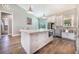 Bright kitchen features a large center island, stainless steel appliances, and tile backsplash at 6344 Old Lake Wilson Rd, Davenport, FL 33896