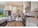 Modern kitchen featuring stainless steel appliances and white cabinets and quartz countertops at 6344 Old Lake Wilson Rd, Davenport, FL 33896