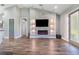 Open-concept living area featuring a stone fireplace, recessed lights, and stylish flooring at 6344 Old Lake Wilson Rd, Davenport, FL 33896