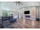 Inviting living room flows into the kitchen and features a stone fireplace and hardwood floors at 6344 Old Lake Wilson Rd, Davenport, FL 33896