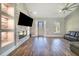 Spacious living room boasts hardwood floors, a stone fireplace, and recessed lighting at 6344 Old Lake Wilson Rd, Davenport, FL 33896