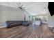 Open-concept living room with high ceilings, wood floors, and a modern kitchen at 6344 Old Lake Wilson Rd, Davenport, FL 33896