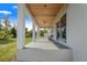 Covered outdoor patio featuring a wood ceiling, ceiling fan, and view of the backyard at 6344 Old Lake Wilson Rd, Davenport, FL 33896