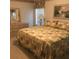 Cozy bedroom with a large bed, neutral-toned walls, and dresser with decorative mirror at 6398 Lolly Bay Ne Loop, Winter Haven, FL 33881