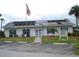 Charming clubhouse with an American flag, manicured landscaping and a convenient parking area at 6398 Lolly Bay Ne Loop, Winter Haven, FL 33881