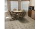 Inviting dining area featuring a round table, four chairs, and light-filled windows overlooking the garden at 6398 Lolly Bay Ne Loop, Winter Haven, FL 33881