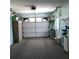 Functional garage with ample storage space and an automatic door opener, offering convenience and security at 6398 Lolly Bay Ne Loop, Winter Haven, FL 33881