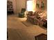 Inviting living room with plush carpeting, a recliner, floral sofa, and a decorative area rug at 6398 Lolly Bay Ne Loop, Winter Haven, FL 33881