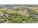 Aerial shot of a property with sprawling land and a home featuring a pool at 6925 Alturas Babson Park Cutoff, Bartow, FL 33830