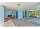 Welcoming carport with a porch swing, seating area, and vibrant blue doors at 6925 Alturas Babson Park Cutoff, Bartow, FL 33830