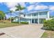 Charming two-story home with a metal roof, light blue siding and a long concrete driveway at 6925 Alturas Babson Park Cutoff, Bartow, FL 33830