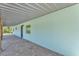 A covered walkway features brick flooring and a colorful exterior at 6925 Alturas Babson Park Cutoff, Bartow, FL 33830