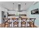 Modern kitchen with white cabinetry, granite countertops, a stainless steel range hood and pendant lighting at 6925 Alturas Babson Park Cutoff, Bartow, FL 33830
