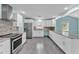 Bright kitchen featuring white cabinets, stainless steel appliances, and granite counters at 6925 Alturas Babson Park Cutoff, Bartow, FL 33830