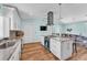 Bright kitchen featuring white cabinetry, granite countertops, stainless steel appliances, and an island with seating at 6925 Alturas Babson Park Cutoff, Bartow, FL 33830