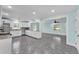 Open kitchen features white cabinets, granite countertops, and gray tile floors at 6925 Alturas Babson Park Cutoff, Bartow, FL 33830