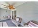 Relaxing lanai with ceiling fan, blue carpet, and wicker furniture with sliding door at 6925 Alturas Babson Park Cutoff, Bartow, FL 33830