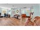 Spacious living room with wood floors, light blue walls, and ample seating at 6925 Alturas Babson Park Cutoff, Bartow, FL 33830