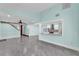 Spacious open-concept living room with grey tile floors, and eat-in bar at 6925 Alturas Babson Park Cutoff, Bartow, FL 33830
