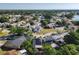 An aerial view of a quaint residential neighborhood with mature trees and lush landscaping at 711 Lake Dexter Cir, Winter Haven, FL 33884