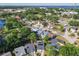 Neighborhood aerial featuring cul-de-sac houses with solar panels next to lake and lush trees at 711 Lake Dexter Cir, Winter Haven, FL 33884