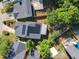 A house with solar panels on the roof sits among neighborhood homes and mature trees at 711 Lake Dexter Cir, Winter Haven, FL 33884