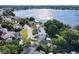 Lakefront homes featuring solar panels, backyard deck, mature trees, and convenient road access at 711 Lake Dexter Cir, Winter Haven, FL 33884