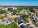 Aerial view of a residential neighborhood with mature trees, streets, and homes in view at 711 Lake Dexter Cir, Winter Haven, FL 33884
