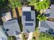 A house with solar panels on the roof is nestled among other houses and mature trees at 711 Lake Dexter Cir, Winter Haven, FL 33884