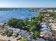 Beautiful aerial view of homes near a sparkling lake and lush green landscape at 711 Lake Dexter Cir, Winter Haven, FL 33884