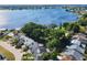Aerial view of a neighborhood bordering a lake, highlighting the community and landscaping at 711 Lake Dexter Cir, Winter Haven, FL 33884