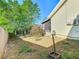 A grassy backyard featuring green foliage and a partial view of the home's exterior at 711 Lake Dexter Cir, Winter Haven, FL 33884