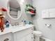 Bright bathroom featuring a white vanity with a round mirror, toilet, decor, and plenty of natural lighting at 711 Lake Dexter Cir, Winter Haven, FL 33884