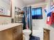 Cozy bathroom featuring a vanity with a modern faucet, toilet, and shower with themed curtain at 711 Lake Dexter Cir, Winter Haven, FL 33884