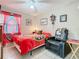Inviting bedroom boasts a ceiling fan, a decorative bedspread, a comfortable chair, and natural lighting at 711 Lake Dexter Cir, Winter Haven, FL 33884