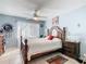 Comfortable bedroom with a bed, nightstand, and natural light streaming through the window, creating a serene atmosphere at 711 Lake Dexter Cir, Winter Haven, FL 33884