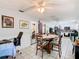 Bright dining area adjacent to a kitchen with tiled floor and white walls at 711 Lake Dexter Cir, Winter Haven, FL 33884